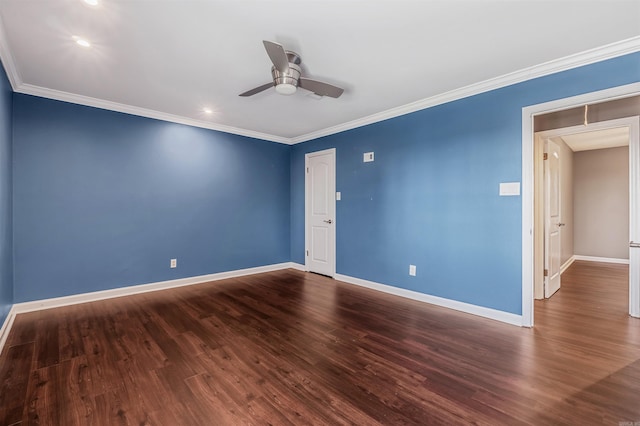 empty room with ornamental molding, dark wood-type flooring, a ceiling fan, and baseboards