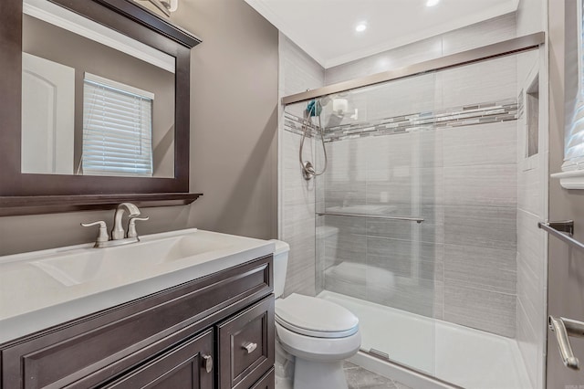 bathroom featuring toilet, a stall shower, and vanity