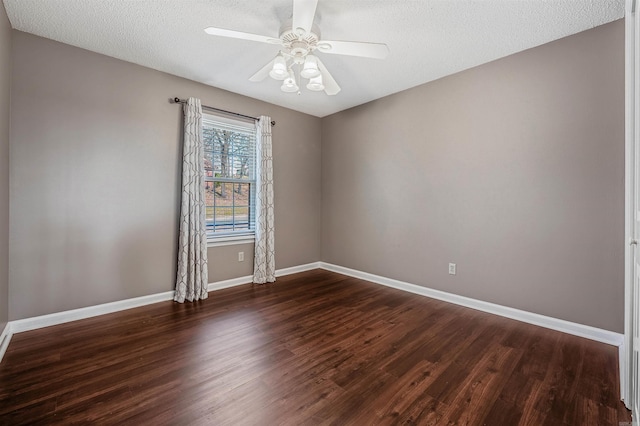 unfurnished room featuring dark wood-type flooring, a textured ceiling, baseboards, and a ceiling fan