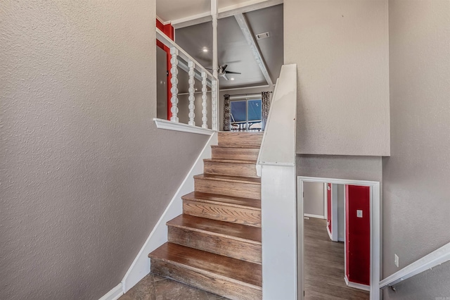 stairs with baseboards and a textured wall