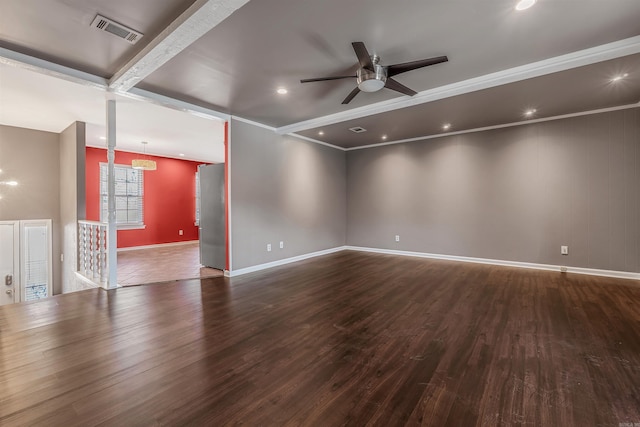 empty room with baseboards, visible vents, a ceiling fan, wood finished floors, and crown molding