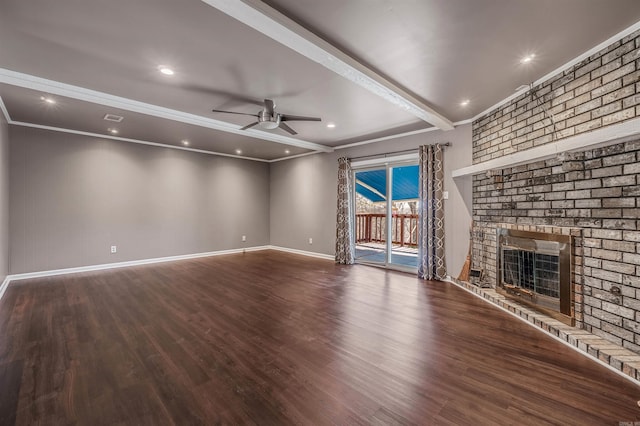 unfurnished living room featuring ceiling fan, a fireplace, wood finished floors, baseboards, and ornamental molding