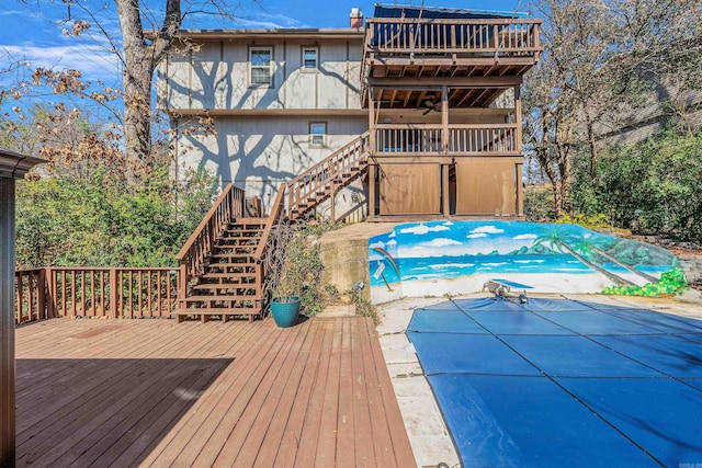 view of swimming pool featuring stairs, a fenced in pool, and a wooden deck