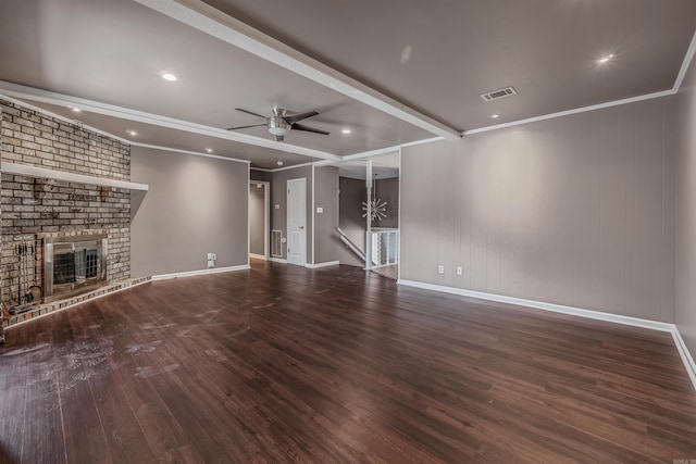 unfurnished living room with visible vents, a ceiling fan, ornamental molding, a brick fireplace, and wood finished floors