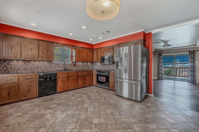 kitchen with visible vents, decorative backsplash, ornamental molding, black appliances, and a sink