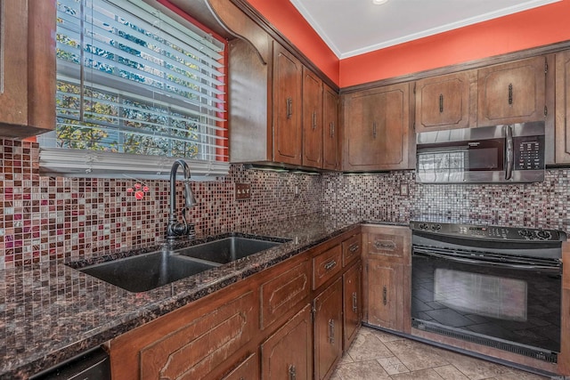 kitchen with black range with electric stovetop, a sink, ornamental molding, backsplash, and stainless steel microwave