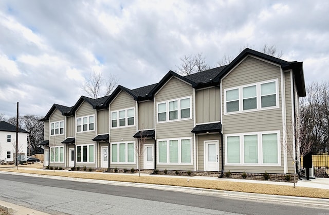 view of property featuring board and batten siding and a residential view