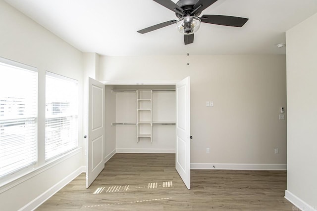 unfurnished bedroom with a closet, light wood-style flooring, and baseboards