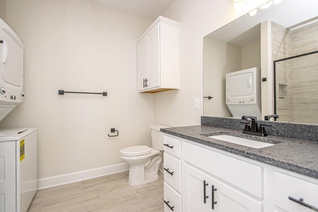 full bath with toilet, vanity, baseboards, stacked washing maching and dryer, and a stall shower