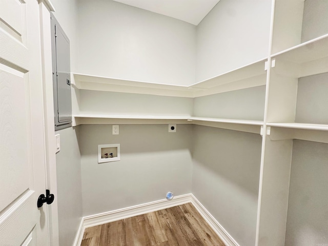 laundry room featuring hookup for a washing machine, hookup for an electric dryer, wood finished floors, laundry area, and baseboards