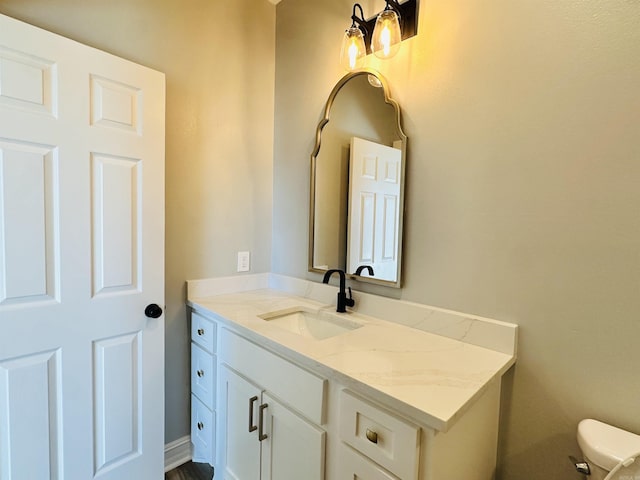 bathroom with toilet and vanity