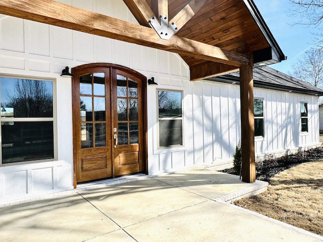 entrance to property featuring board and batten siding and french doors