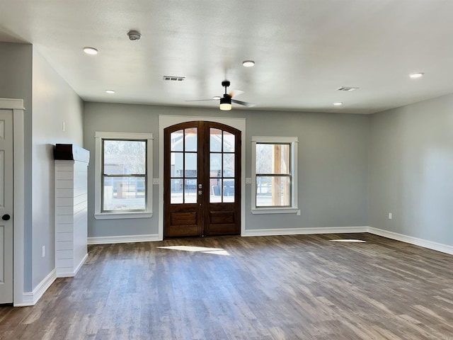 entryway featuring french doors, visible vents, dark wood finished floors, and baseboards