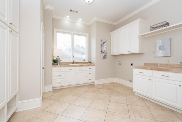 laundry area featuring light tile patterned flooring, visible vents, cabinet space, electric dryer hookup, and crown molding