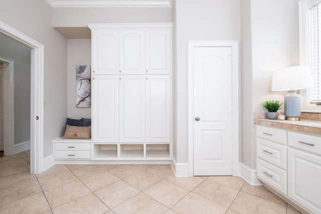 mudroom featuring light tile patterned floors and baseboards