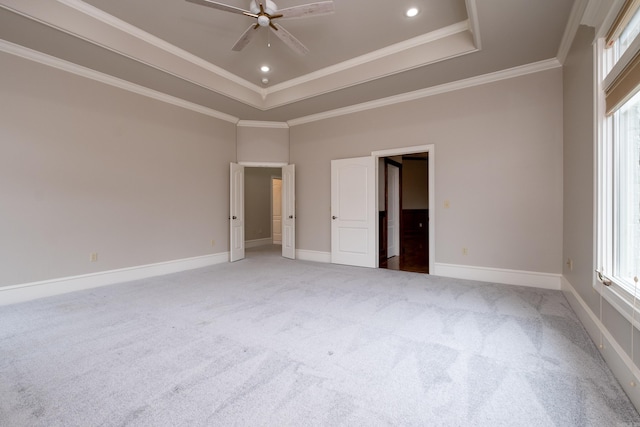 unfurnished bedroom featuring recessed lighting, carpet flooring, baseboards, ornamental molding, and a tray ceiling