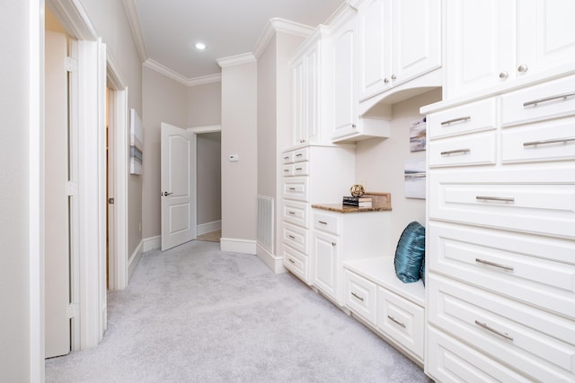 interior space with light carpet, visible vents, baseboards, ornamental molding, and recessed lighting