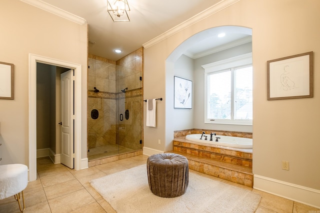 full bathroom featuring a garden tub, ornamental molding, a stall shower, baseboards, and tile patterned floors