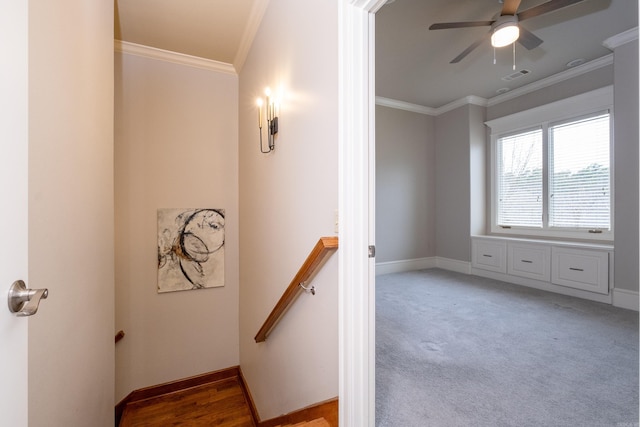 stairway featuring carpet flooring, visible vents, crown molding, and baseboards