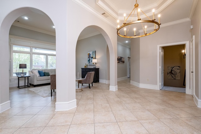 interior space featuring light tile patterned floors, a tray ceiling, and crown molding