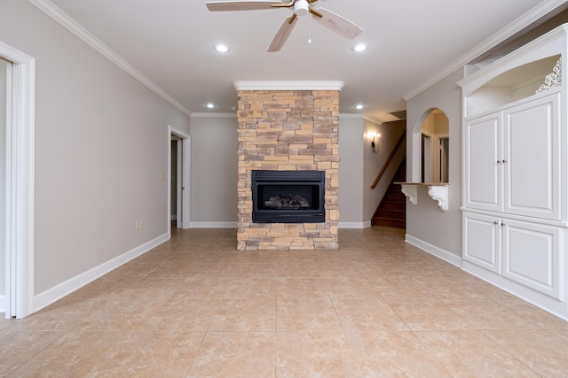 unfurnished living room featuring baseboards, a fireplace, stairway, and crown molding