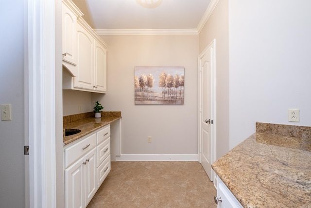 interior space featuring baseboards, light tile patterned floors, and crown molding