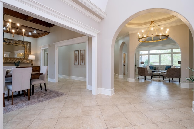 dining area featuring a notable chandelier, a high ceiling, and crown molding