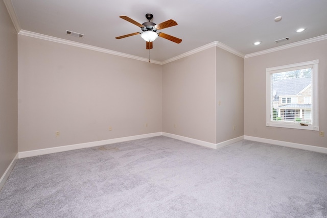 empty room featuring visible vents, ornamental molding, light carpet, ceiling fan, and baseboards