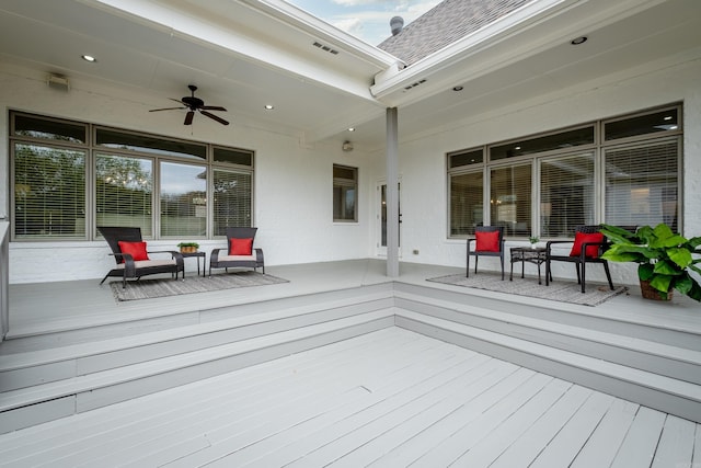 wooden terrace with ceiling fan and visible vents