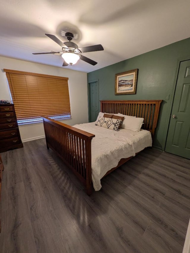 bedroom with a ceiling fan and dark wood-style flooring