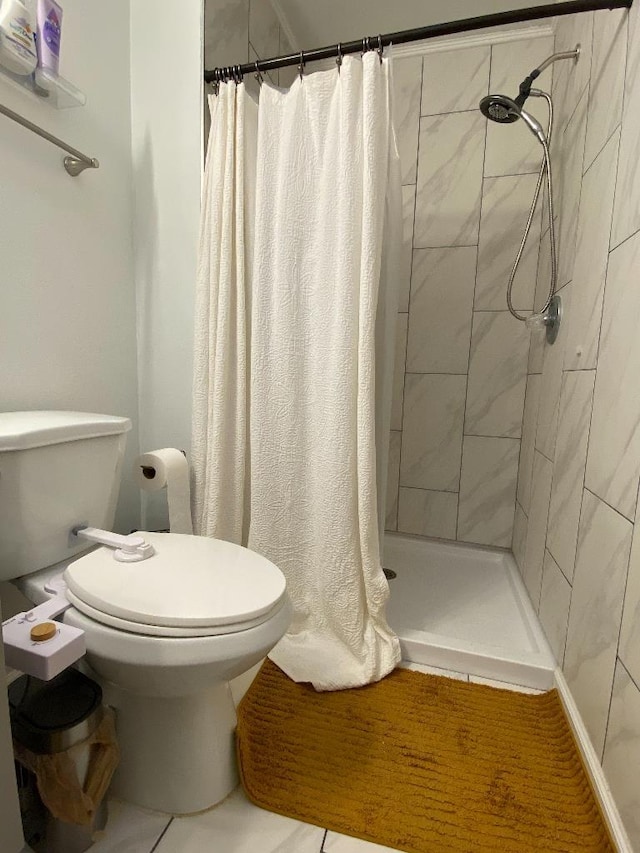 bathroom with a stall shower and toilet