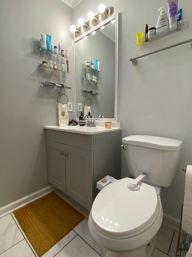 bathroom with marble finish floor, baseboards, vanity, and toilet