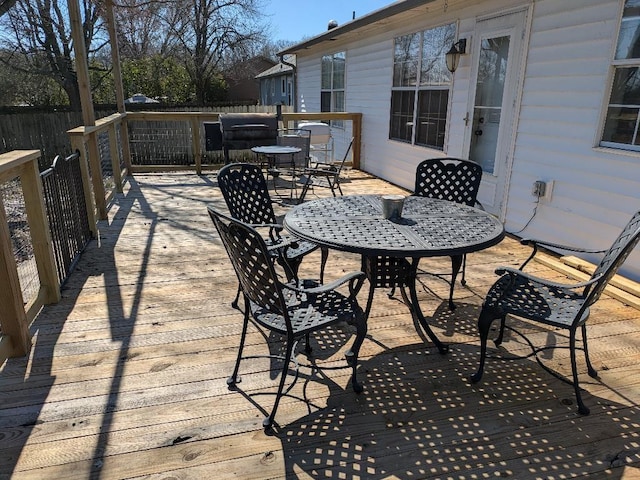 wooden terrace featuring outdoor dining space