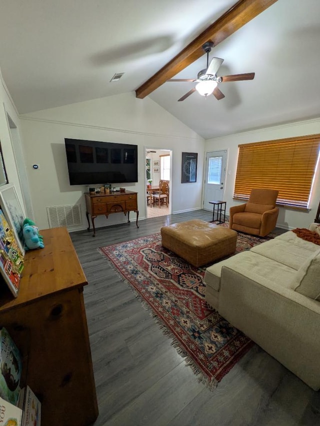 living area featuring a ceiling fan, visible vents, vaulted ceiling with beams, and wood finished floors