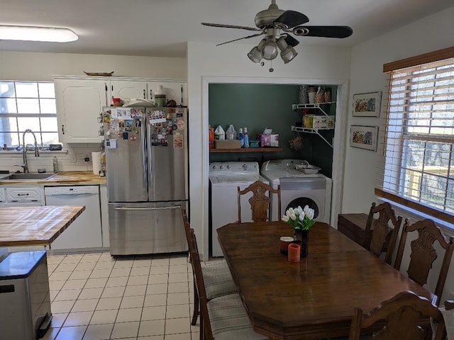 dining area with washer and dryer, a healthy amount of sunlight, ceiling fan, and light tile patterned floors