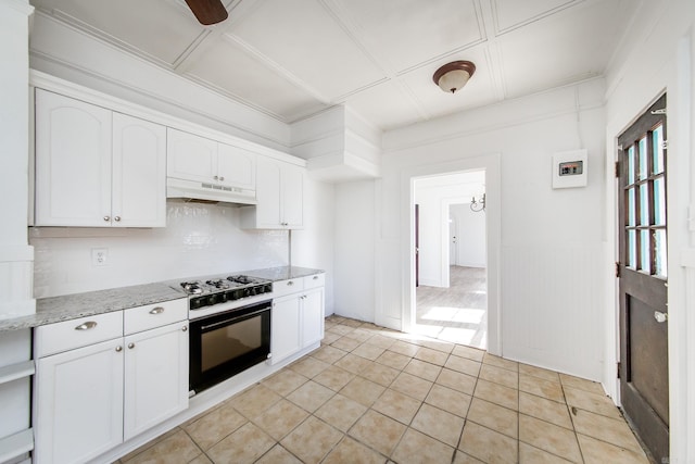 kitchen featuring white cabinets, gas range, oven, and under cabinet range hood