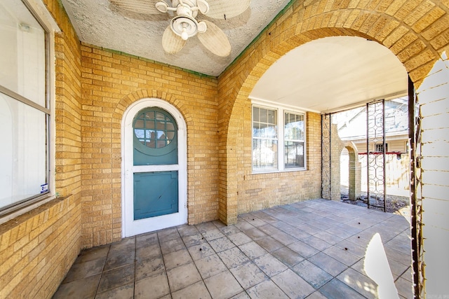 entrance to property featuring ceiling fan