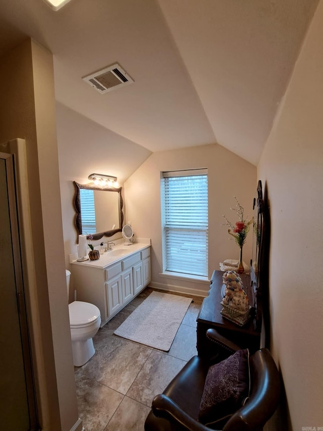 bathroom featuring lofted ceiling, toilet, vanity, and visible vents