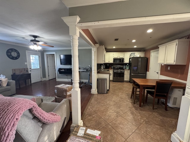 interior space with appliances with stainless steel finishes, open floor plan, tile patterned floors, crown molding, and recessed lighting