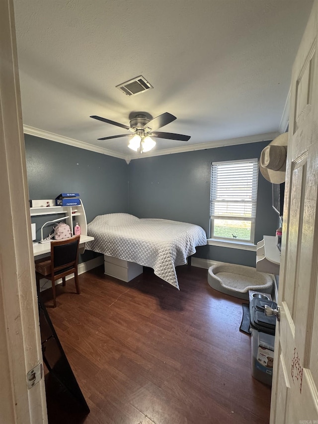 bedroom featuring visible vents, baseboards, a ceiling fan, ornamental molding, and wood finished floors