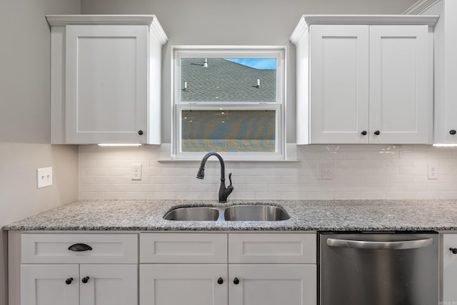 kitchen featuring white cabinetry, dishwasher, and a sink