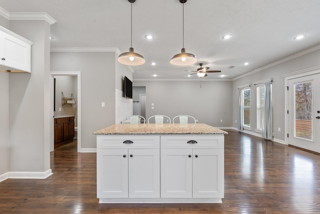 kitchen with white cabinetry, baseboards, dark wood-style flooring, and decorative light fixtures