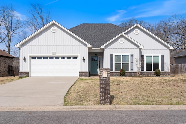 view of front facade featuring roof with shingles, brick siding, fence, a garage, and driveway