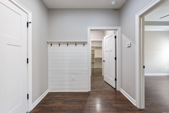 mudroom featuring dark wood-style flooring and baseboards