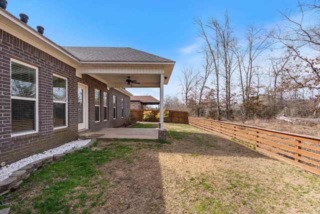 view of yard featuring a patio area, ceiling fan, and a fenced backyard