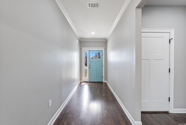 entryway with baseboards, visible vents, wood finished floors, and ornamental molding