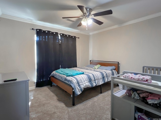 bedroom featuring visible vents, crown molding, baseboards, ceiling fan, and light carpet