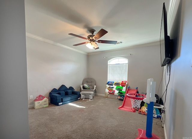 rec room with a ceiling fan, crown molding, carpet, and visible vents