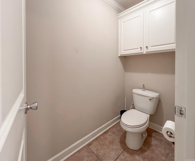 bathroom featuring tile patterned flooring, toilet, and baseboards