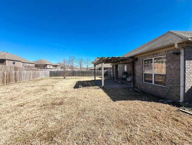 view of yard with a patio, a fenced backyard, and a pergola